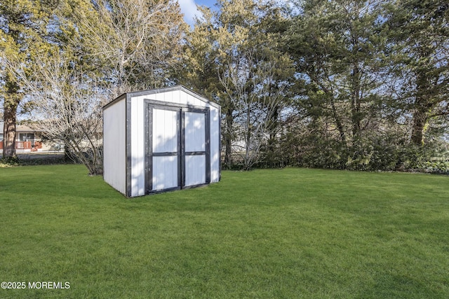 view of outbuilding featuring a yard