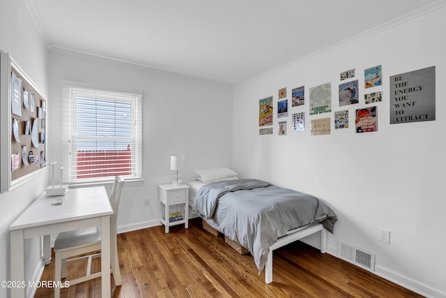 bedroom with ornamental molding and hardwood / wood-style flooring