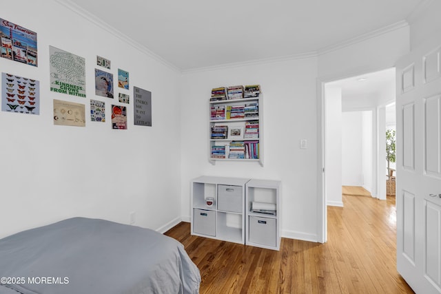 bedroom with crown molding and hardwood / wood-style flooring