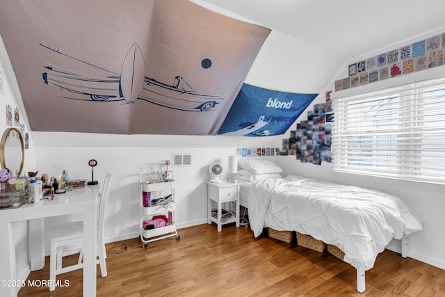 bedroom featuring vaulted ceiling and hardwood / wood-style flooring