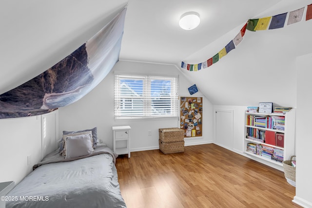 bedroom featuring vaulted ceiling and hardwood / wood-style flooring