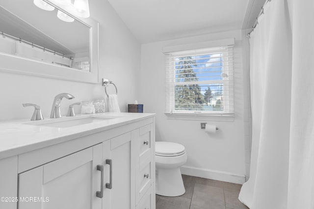 bathroom with tile patterned floors, vanity, and toilet