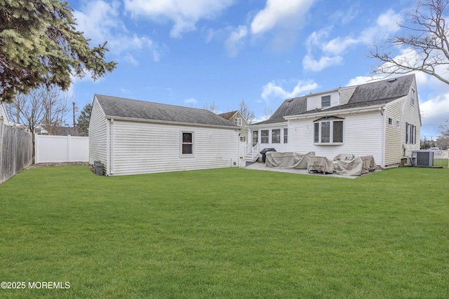 rear view of property featuring a yard and central AC unit