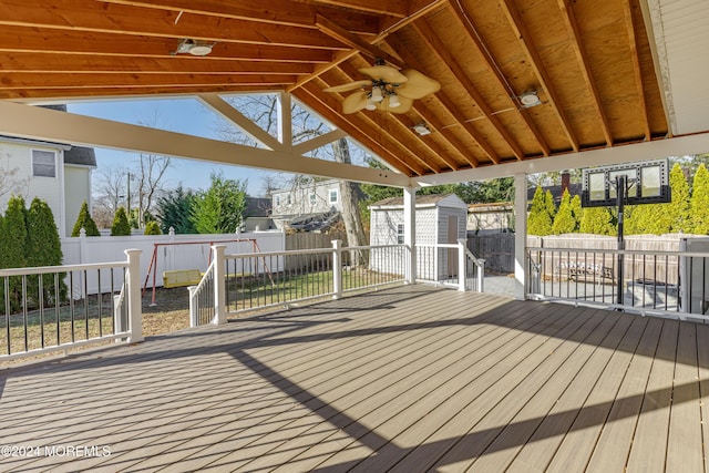 deck with ceiling fan and a storage unit