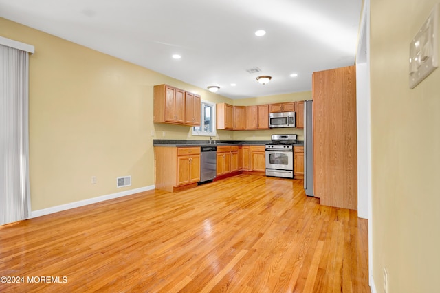 kitchen with stainless steel appliances and light wood-type flooring