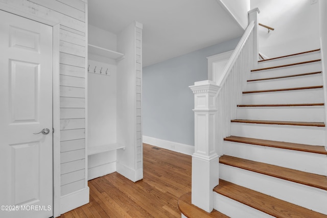 stairs featuring hardwood / wood-style floors