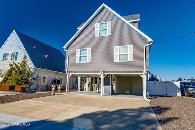 back of property with a carport