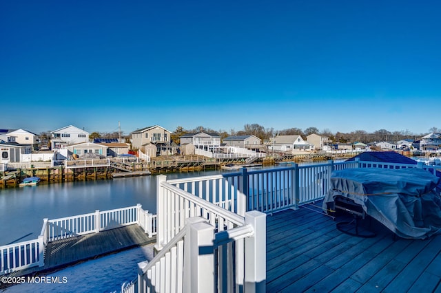 view of dock with a deck with water view