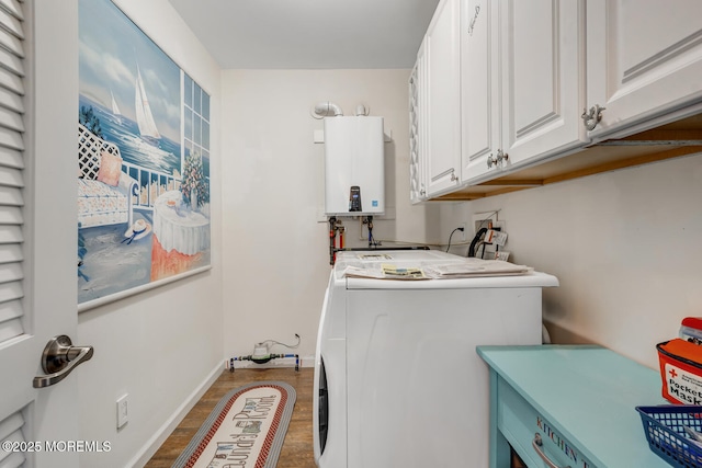 clothes washing area with water heater, cabinets, wood-type flooring, and washer and clothes dryer