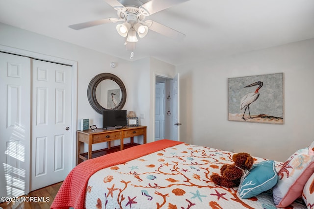 bedroom with ceiling fan, a closet, and hardwood / wood-style floors