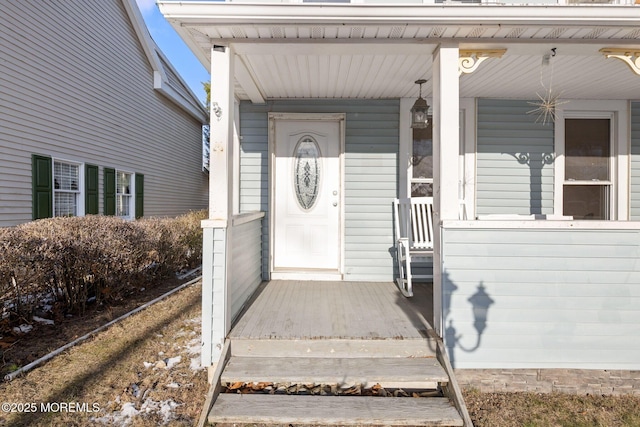 view of exterior entry with a porch