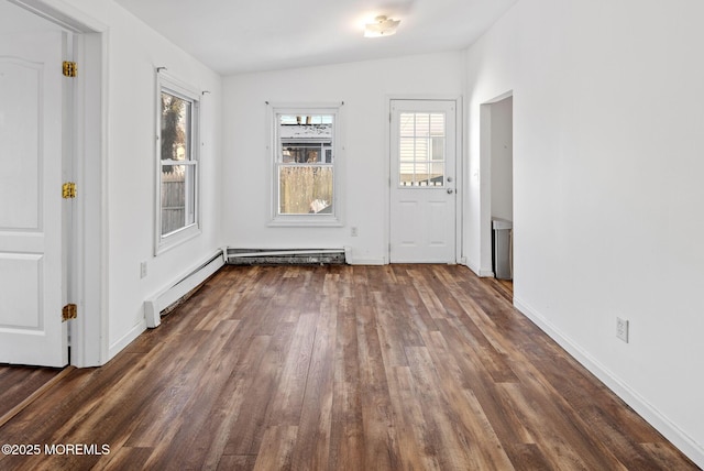 foyer entrance with dark hardwood / wood-style floors and a baseboard heating unit