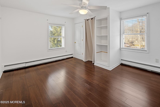 unfurnished bedroom with a baseboard heating unit, ceiling fan, and dark hardwood / wood-style floors