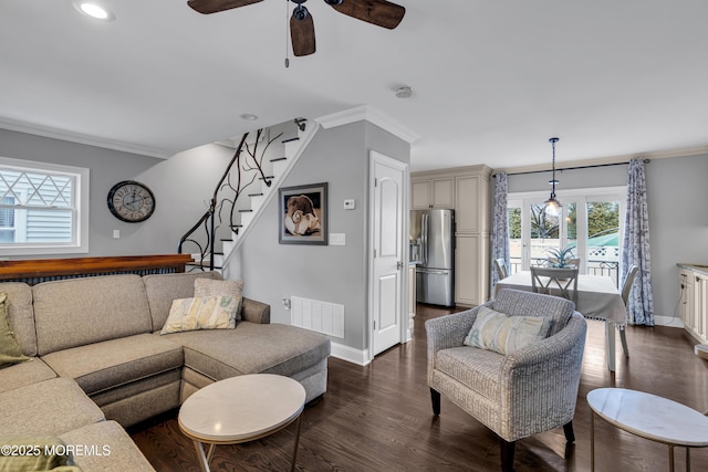 living room featuring ceiling fan, dark wood-type flooring, and ornamental molding