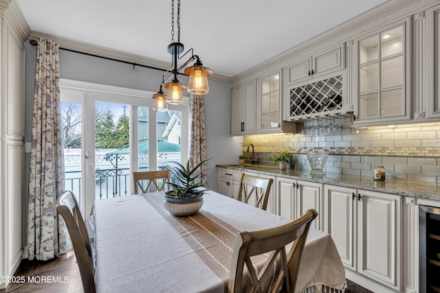 dining room featuring wet bar and wine cooler