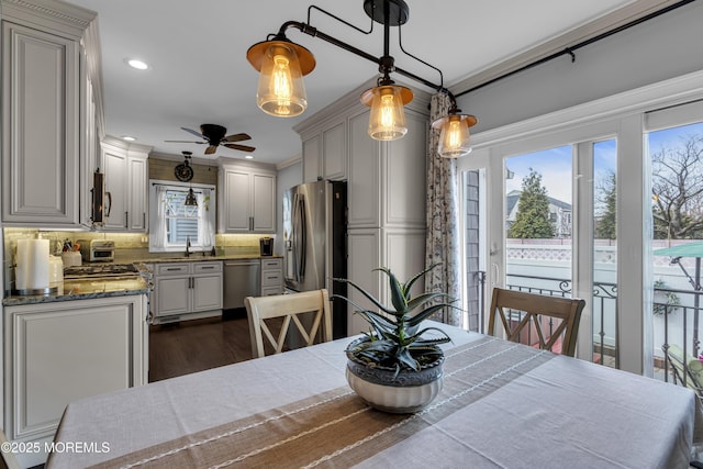 dining space with ceiling fan and dark hardwood / wood-style floors