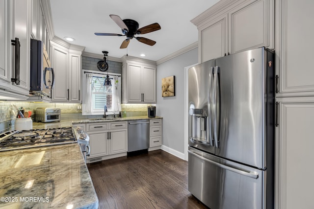 kitchen with light stone countertops, white cabinets, dark hardwood / wood-style flooring, stainless steel appliances, and sink