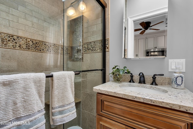 bathroom with ceiling fan, walk in shower, and vanity