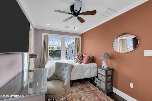 bedroom featuring ceiling fan, dark hardwood / wood-style flooring, and crown molding