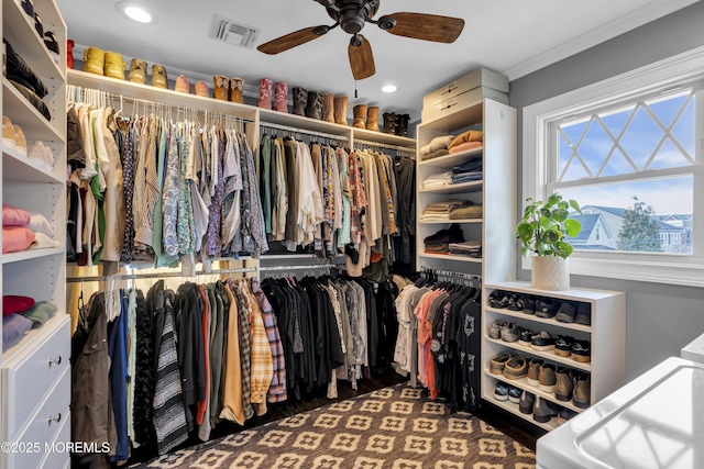 walk in closet featuring ceiling fan