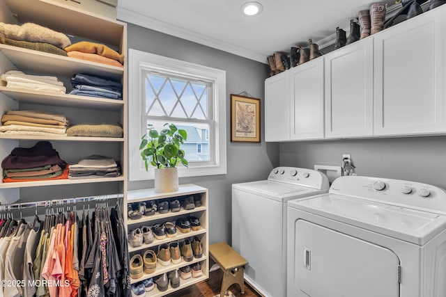 clothes washing area featuring cabinets, separate washer and dryer, and ornamental molding