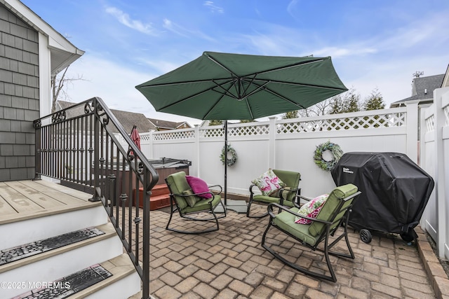 view of patio with a hot tub and area for grilling