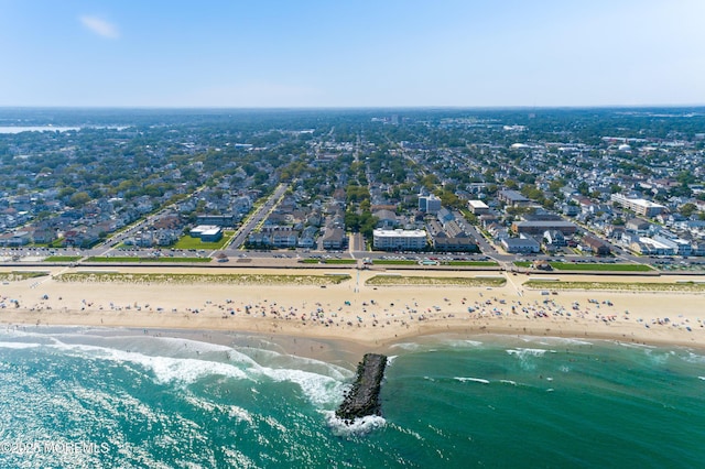 birds eye view of property featuring a beach view and a water view