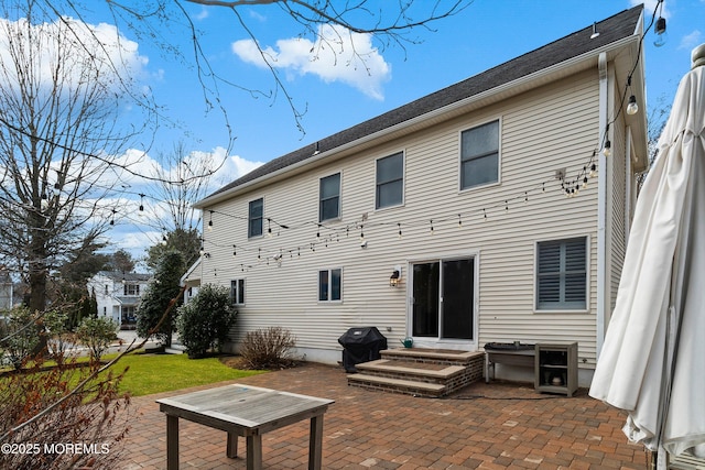 rear view of house with entry steps and a patio area