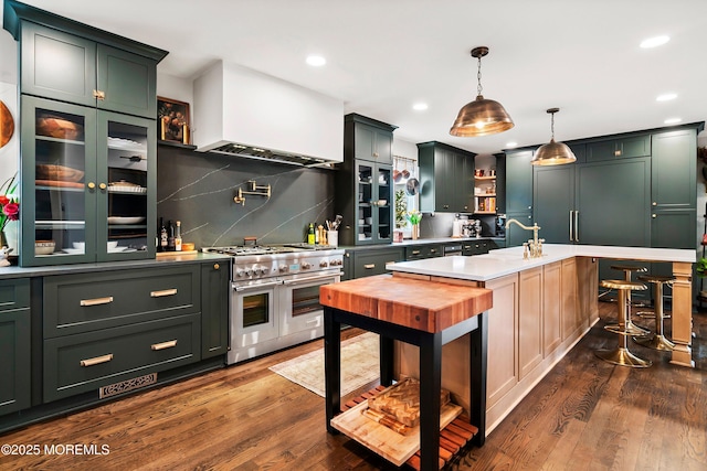 kitchen with range with two ovens, decorative light fixtures, dark wood finished floors, open shelves, and decorative backsplash