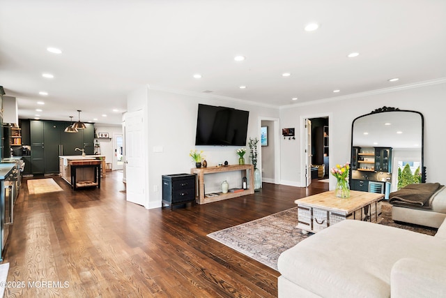 living room featuring ornamental molding, dark wood finished floors, and recessed lighting