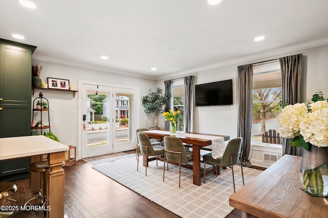 dining room with recessed lighting, plenty of natural light, wood finished floors, and crown molding