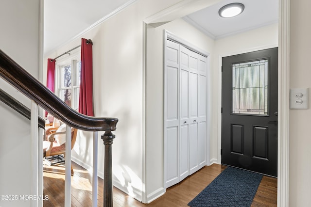 foyer entrance with wood-type flooring and ornamental molding