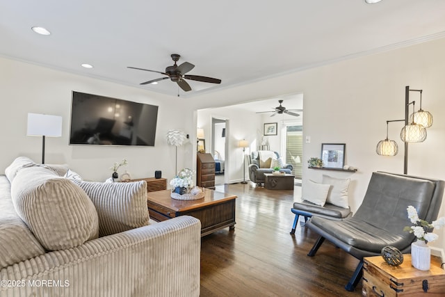 living room with ceiling fan, dark wood-type flooring, and ornamental molding