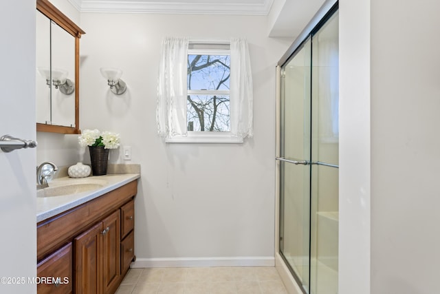 bathroom featuring walk in shower, vanity, tile patterned floors, and crown molding