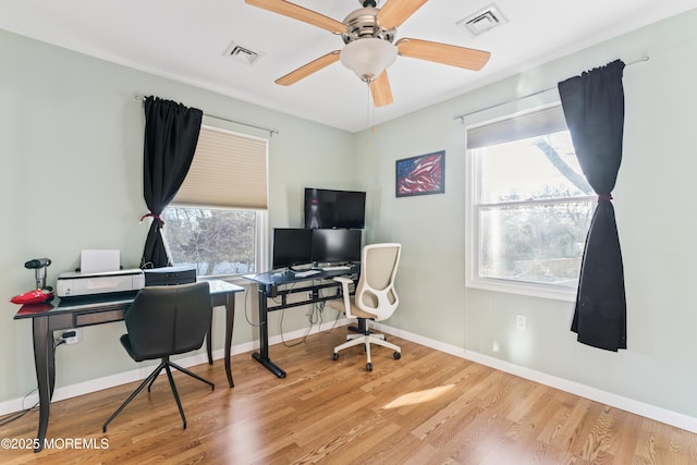 office area with ceiling fan, a wealth of natural light, and light hardwood / wood-style floors