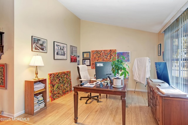 office area featuring lofted ceiling and light wood-type flooring