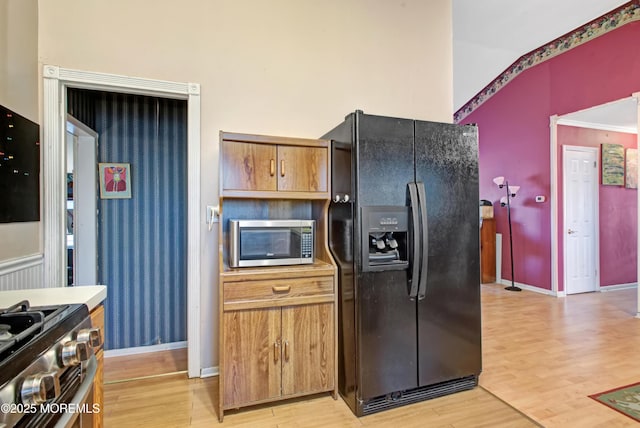 kitchen featuring stainless steel appliances and light hardwood / wood-style flooring