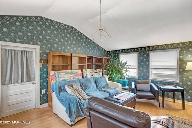 living room with lofted ceiling and light hardwood / wood-style flooring