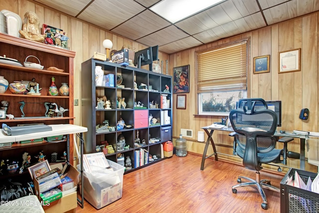 home office featuring wood walls and hardwood / wood-style flooring