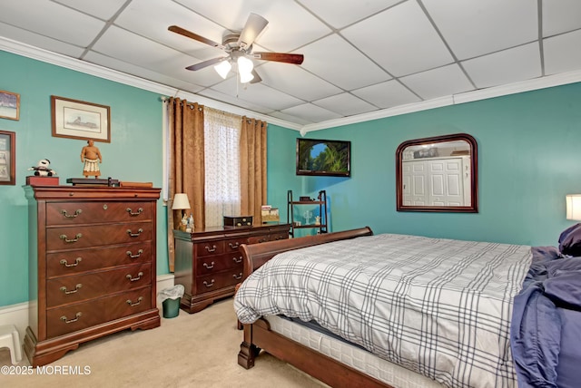 bedroom featuring a paneled ceiling, carpet floors, ceiling fan, and ornamental molding