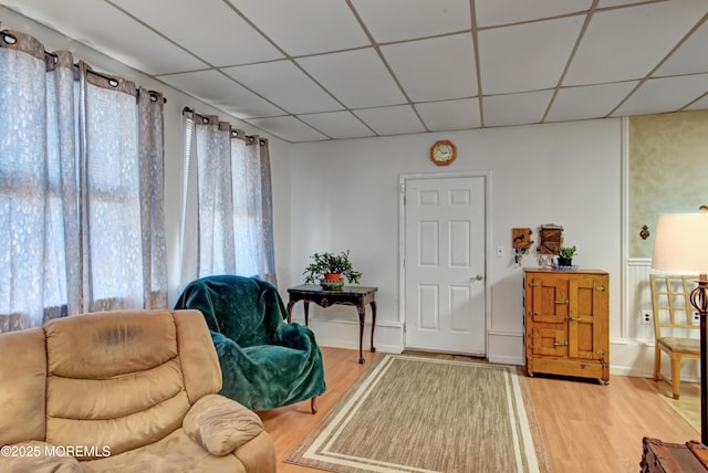 sitting room featuring hardwood / wood-style flooring and a drop ceiling