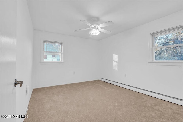 empty room with light carpet, a baseboard heating unit, and ceiling fan