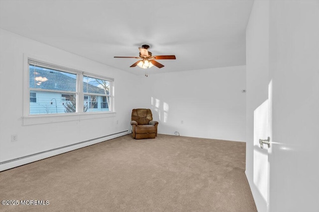 carpeted spare room featuring ceiling fan and a baseboard radiator