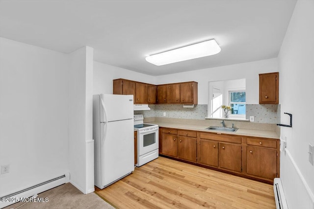 kitchen featuring sink, white appliances, a baseboard radiator, and light hardwood / wood-style flooring