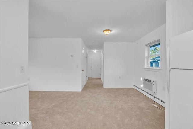 empty room featuring a baseboard radiator, a wall mounted air conditioner, and light carpet