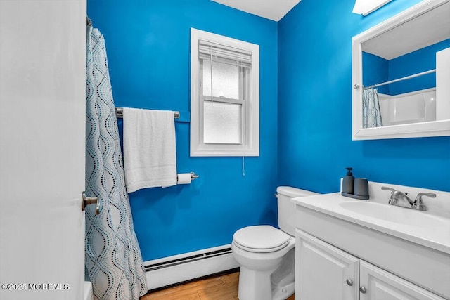 bathroom with hardwood / wood-style floors, toilet, walk in shower, vanity, and baseboard heating