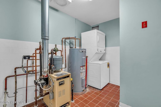 utilities with water heater and stacked washing maching and dryer