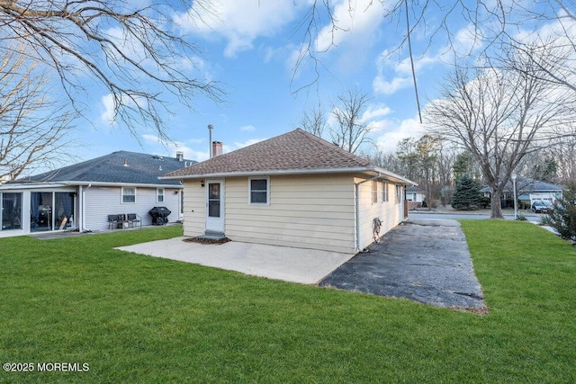 back of house featuring a patio area and a yard