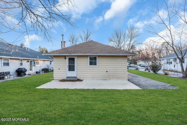 back of house with a patio area, central AC unit, and a yard