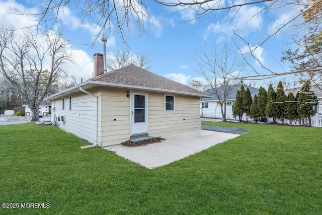 rear view of property with a lawn and a patio area